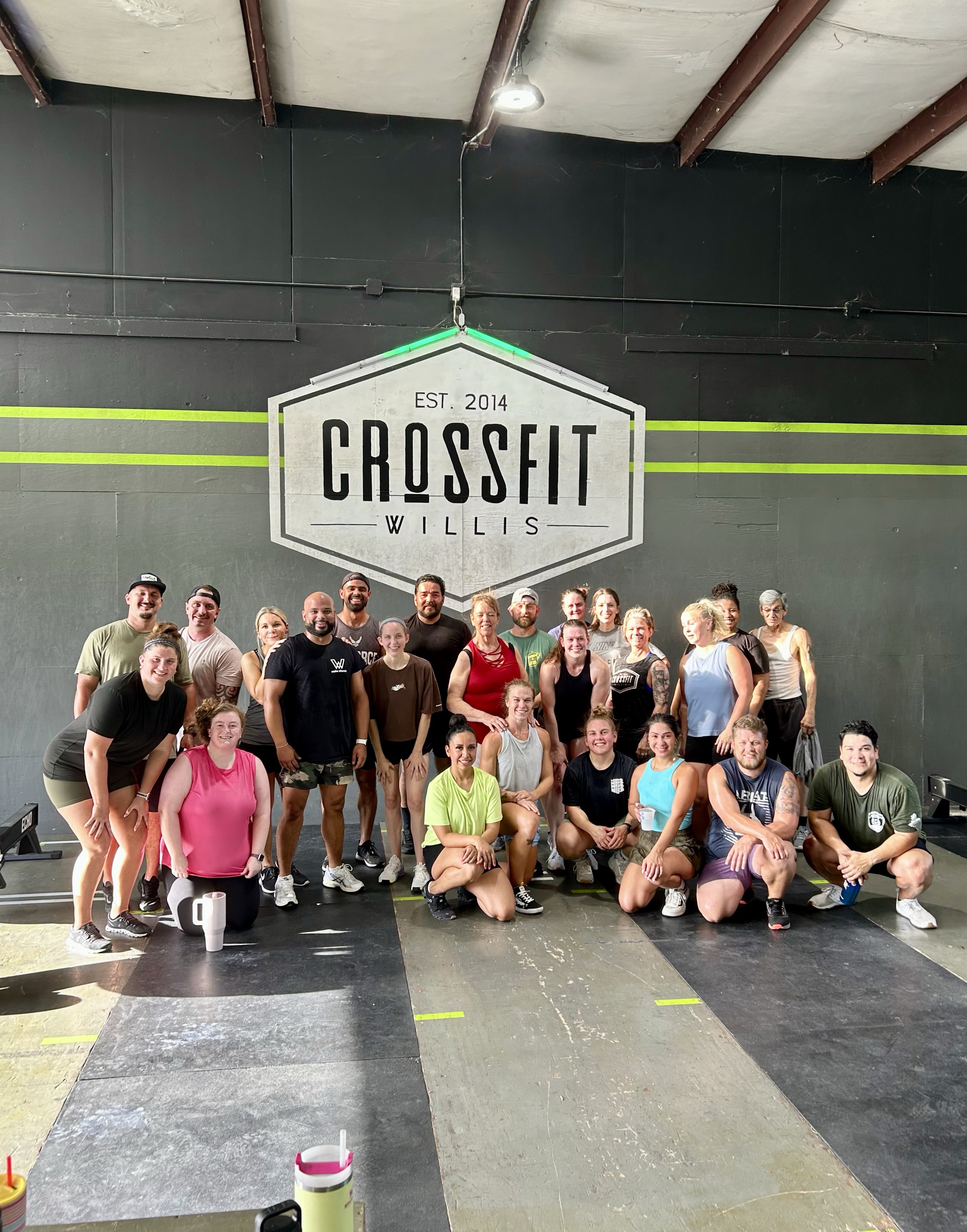 CrossFit Willis members in front of the gym sign